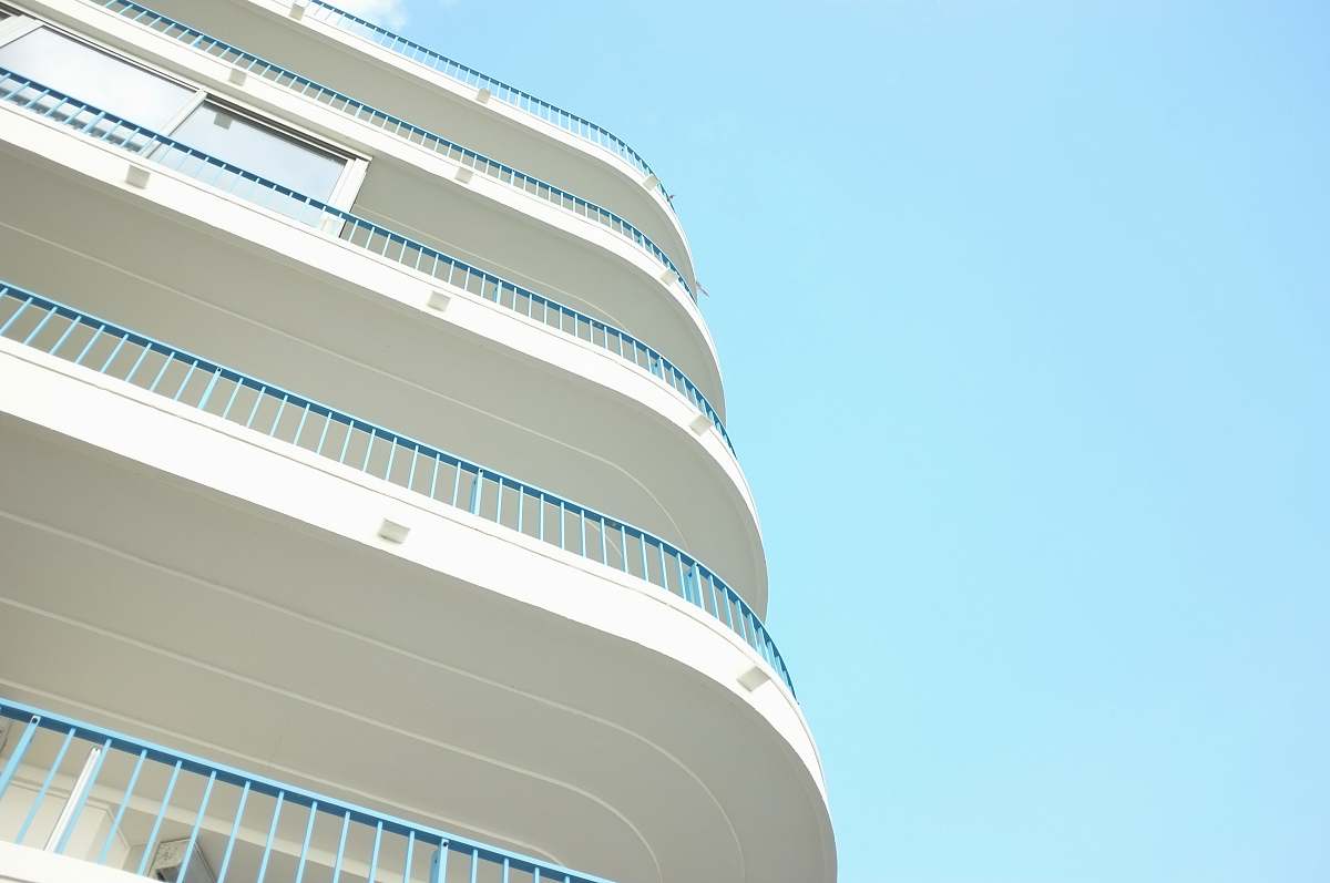 blue sky worms eye view photography of building railing